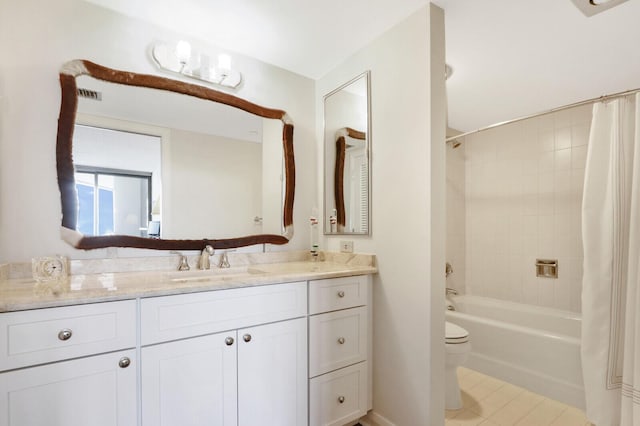 full bathroom featuring tile patterned flooring, shower / tub combo, vanity, and toilet