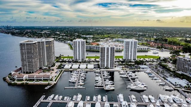 aerial view at dusk featuring a water view