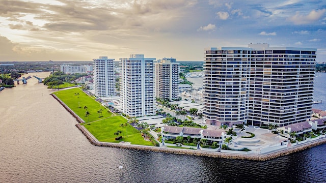 aerial view at dusk featuring a water view