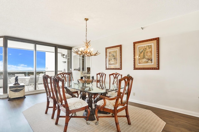 dining space with a textured ceiling, floor to ceiling windows, a chandelier, and dark hardwood / wood-style floors