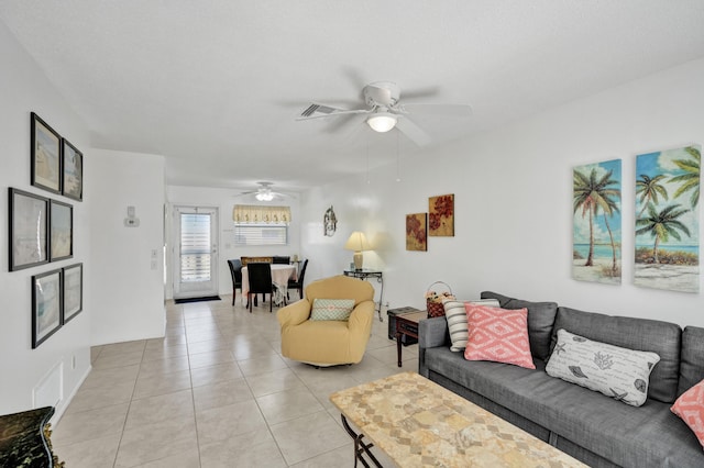 living room featuring light tile patterned floors and ceiling fan