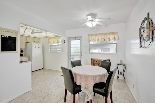 tiled dining area with ceiling fan