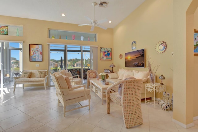 living room with plenty of natural light, ceiling fan, light tile patterned flooring, and high vaulted ceiling