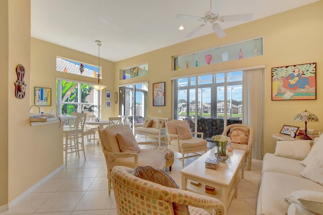 living room with ceiling fan, light tile patterned floors, and a healthy amount of sunlight