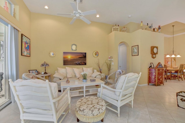 living room featuring ceiling fan with notable chandelier, light tile patterned flooring, and high vaulted ceiling