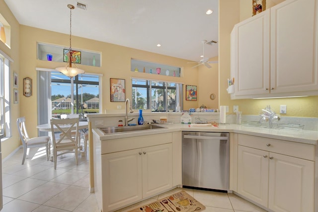 kitchen featuring kitchen peninsula, sink, stainless steel dishwasher, decorative light fixtures, and white cabinetry