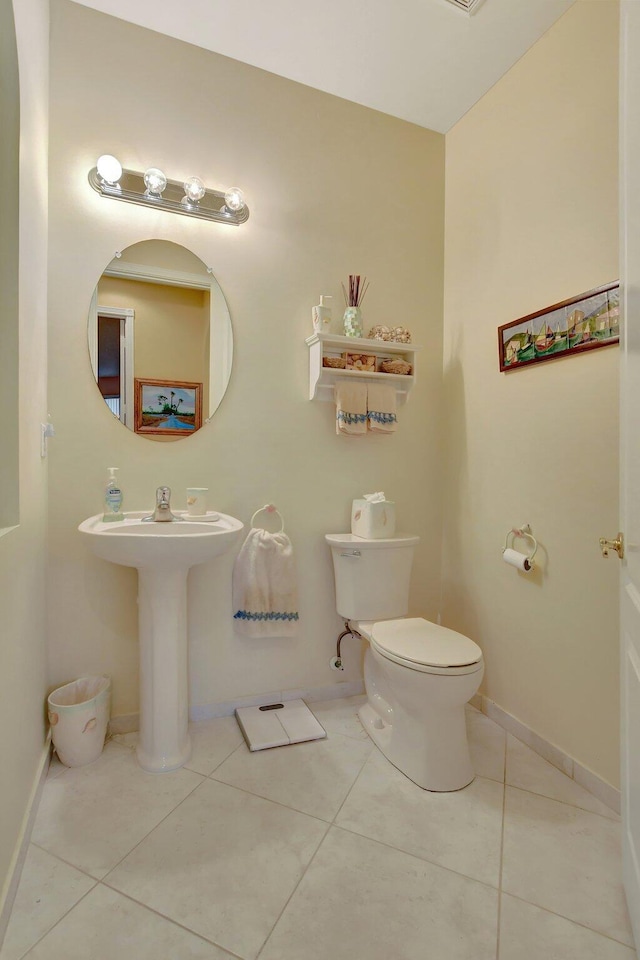 bathroom with tile patterned floors, toilet, and sink