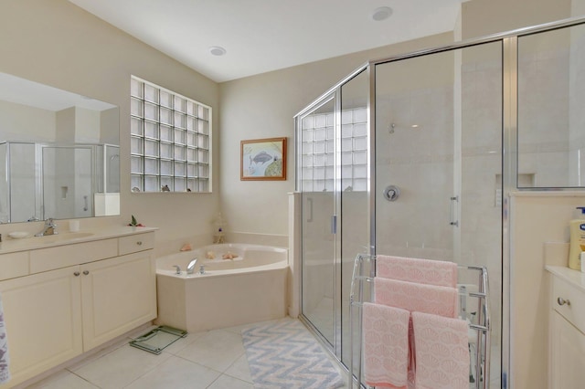 bathroom with tile patterned flooring, vanity, and separate shower and tub