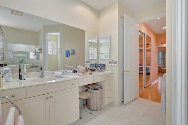 bathroom with hardwood / wood-style floors, vanity, and toilet