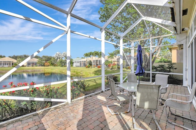 unfurnished sunroom featuring a swimming pool and a water view