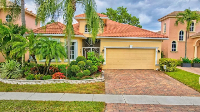 mediterranean / spanish-style home with a garage