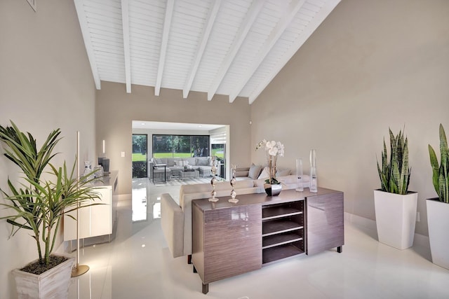 living room featuring beamed ceiling and high vaulted ceiling