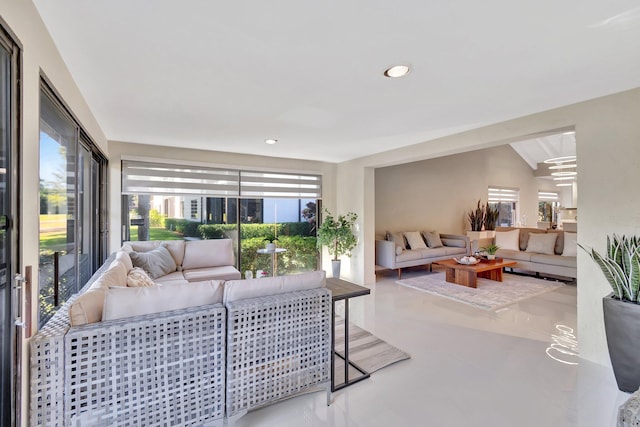 living room with concrete flooring and vaulted ceiling