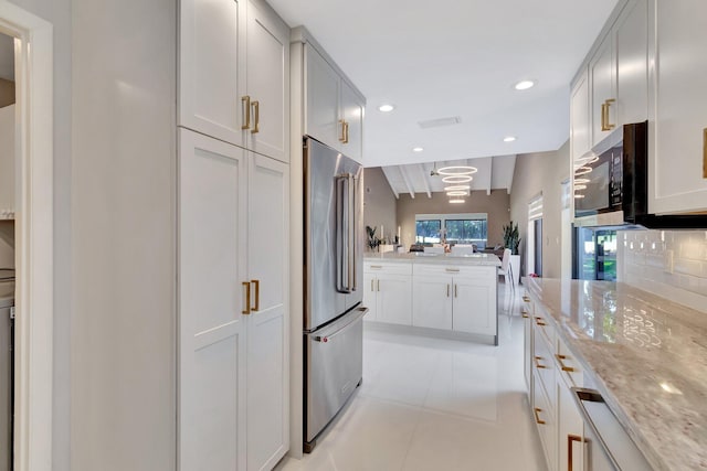 kitchen with white cabinets, decorative backsplash, light tile patterned floors, and appliances with stainless steel finishes