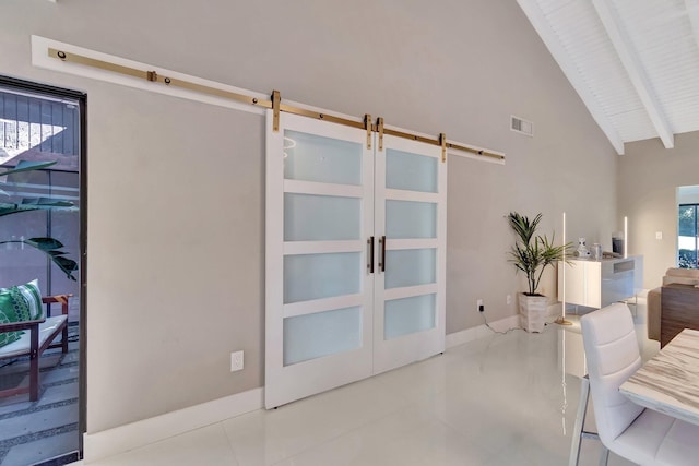 tiled living room featuring french doors, a barn door, a healthy amount of sunlight, and beam ceiling