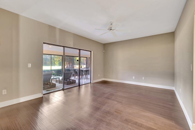 spare room with dark hardwood / wood-style floors and ceiling fan