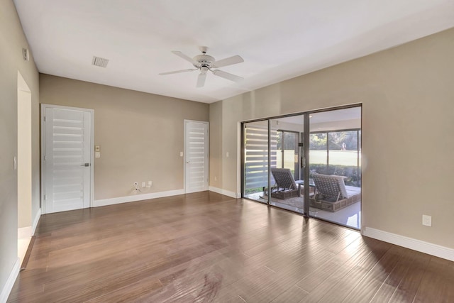 spare room featuring ceiling fan and dark hardwood / wood-style flooring