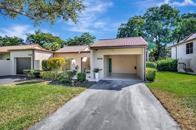 mediterranean / spanish home with a carport and a front yard