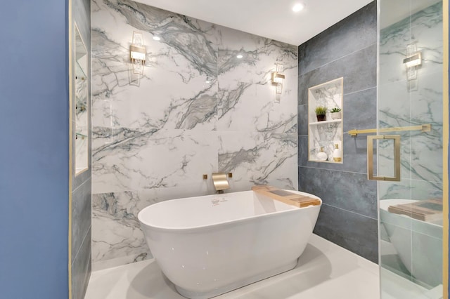 bathroom with a tub and tile walls