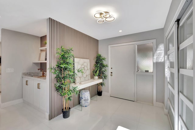 tiled foyer entrance featuring sink