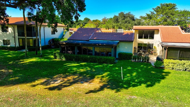 back of property featuring a yard and a patio