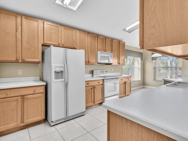 kitchen with light tile patterned flooring and white appliances