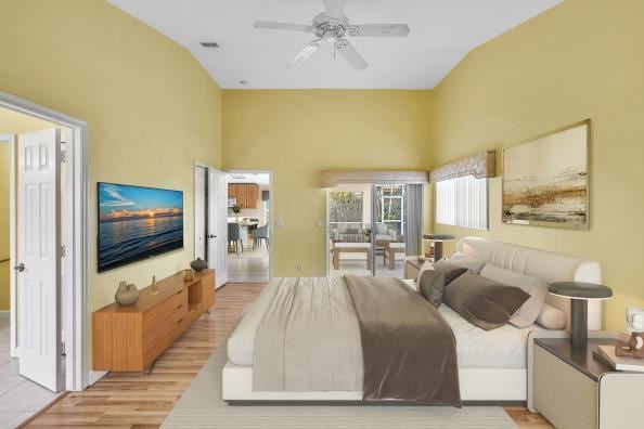 bedroom featuring ceiling fan, vaulted ceiling, and light hardwood / wood-style flooring