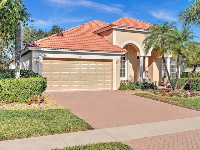 mediterranean / spanish home featuring a garage