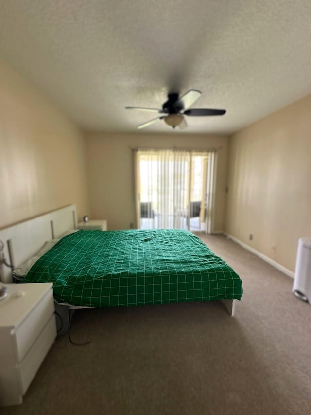 carpeted bedroom featuring a textured ceiling and ceiling fan