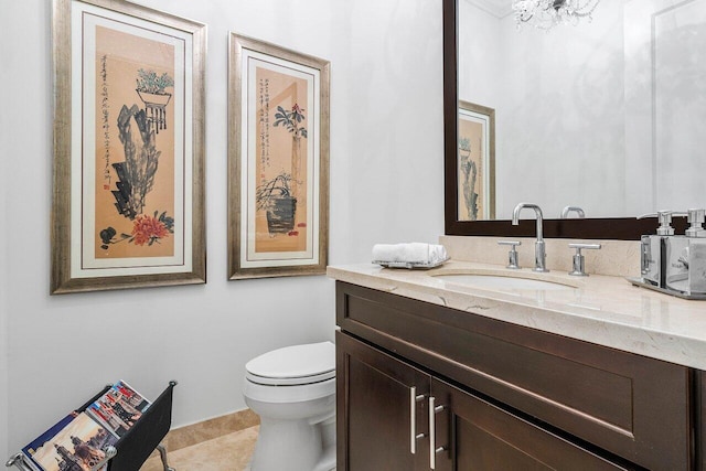 bathroom with tile patterned flooring, vanity, and toilet