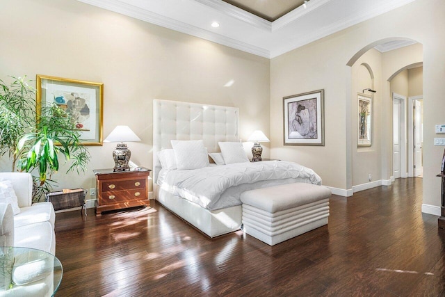 bedroom featuring a towering ceiling, crown molding, and dark wood-type flooring