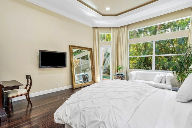 bedroom with ornamental molding, a tray ceiling, multiple windows, and dark wood-type flooring