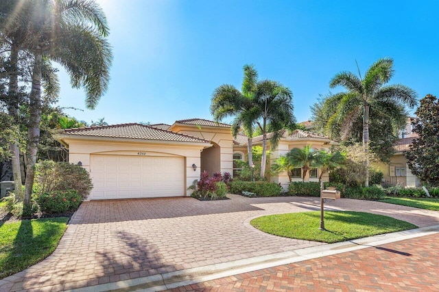 mediterranean / spanish-style home with a garage