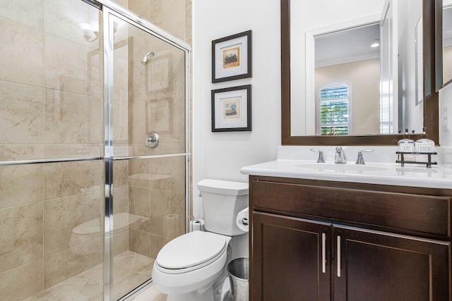 bathroom with vanity, toilet, walk in shower, and ornamental molding