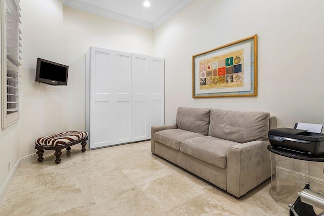 living room with a towering ceiling and ornamental molding