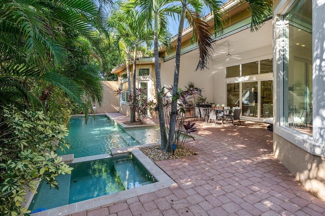 view of pool with a patio area, an in ground hot tub, and ceiling fan