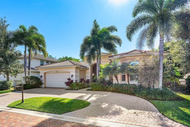 mediterranean / spanish house with a garage