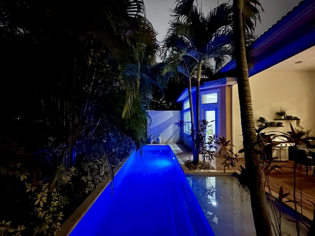 view of pool at night