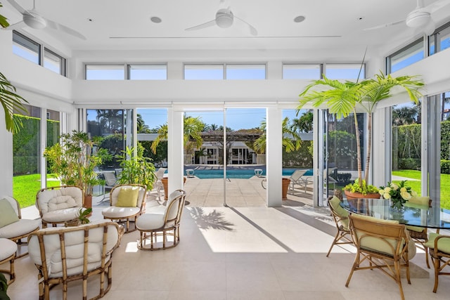 sunroom / solarium featuring ceiling fan