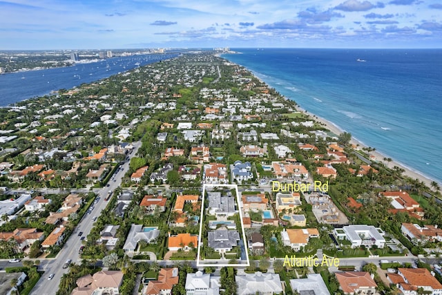 drone / aerial view featuring a water view and a beach view