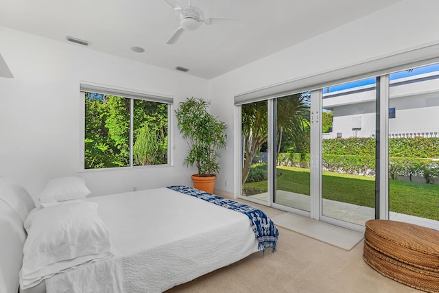 carpeted bedroom with ceiling fan and access to outside