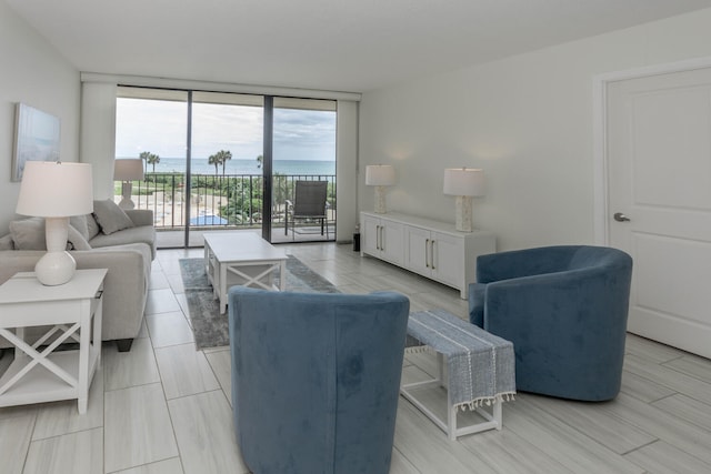 living room with a water view and floor to ceiling windows