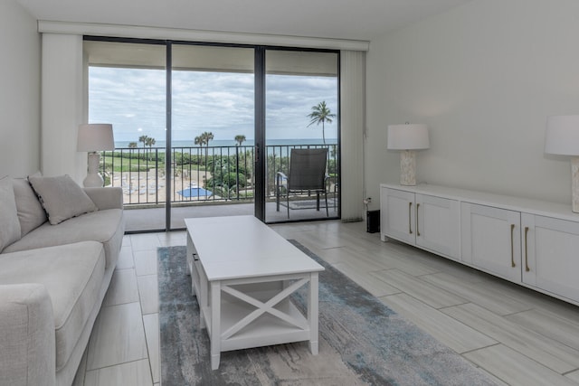 living room with a water view and a wall of windows