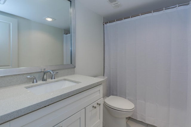 bathroom featuring tile patterned floors, vanity, and toilet