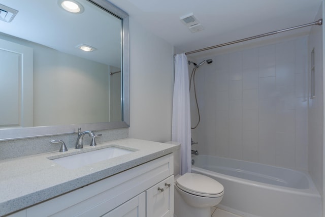 full bathroom with tile patterned floors, vanity, toilet, and shower / bath combo with shower curtain