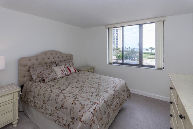 bedroom featuring light carpet