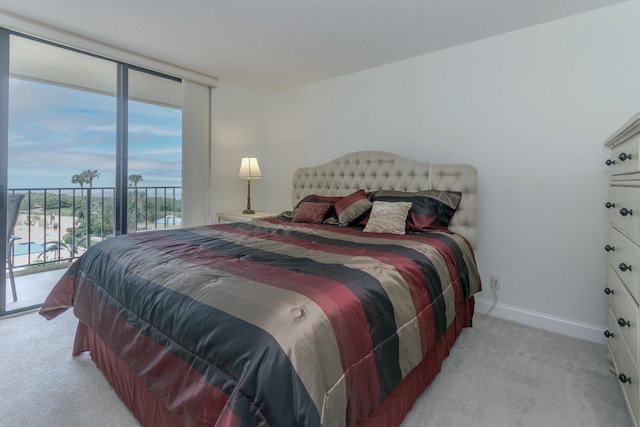 carpeted bedroom featuring access to outside and multiple windows