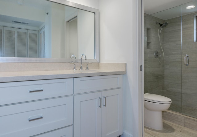 bathroom featuring walk in shower, vanity, and toilet