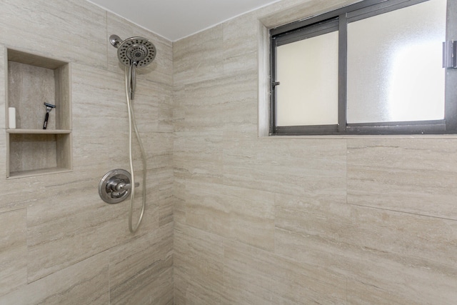 bathroom with tiled shower