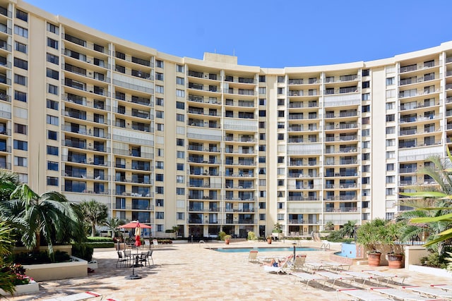 view of building exterior featuring a community pool